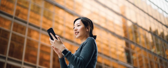 Businesswoman Using her Smartphone in the Street